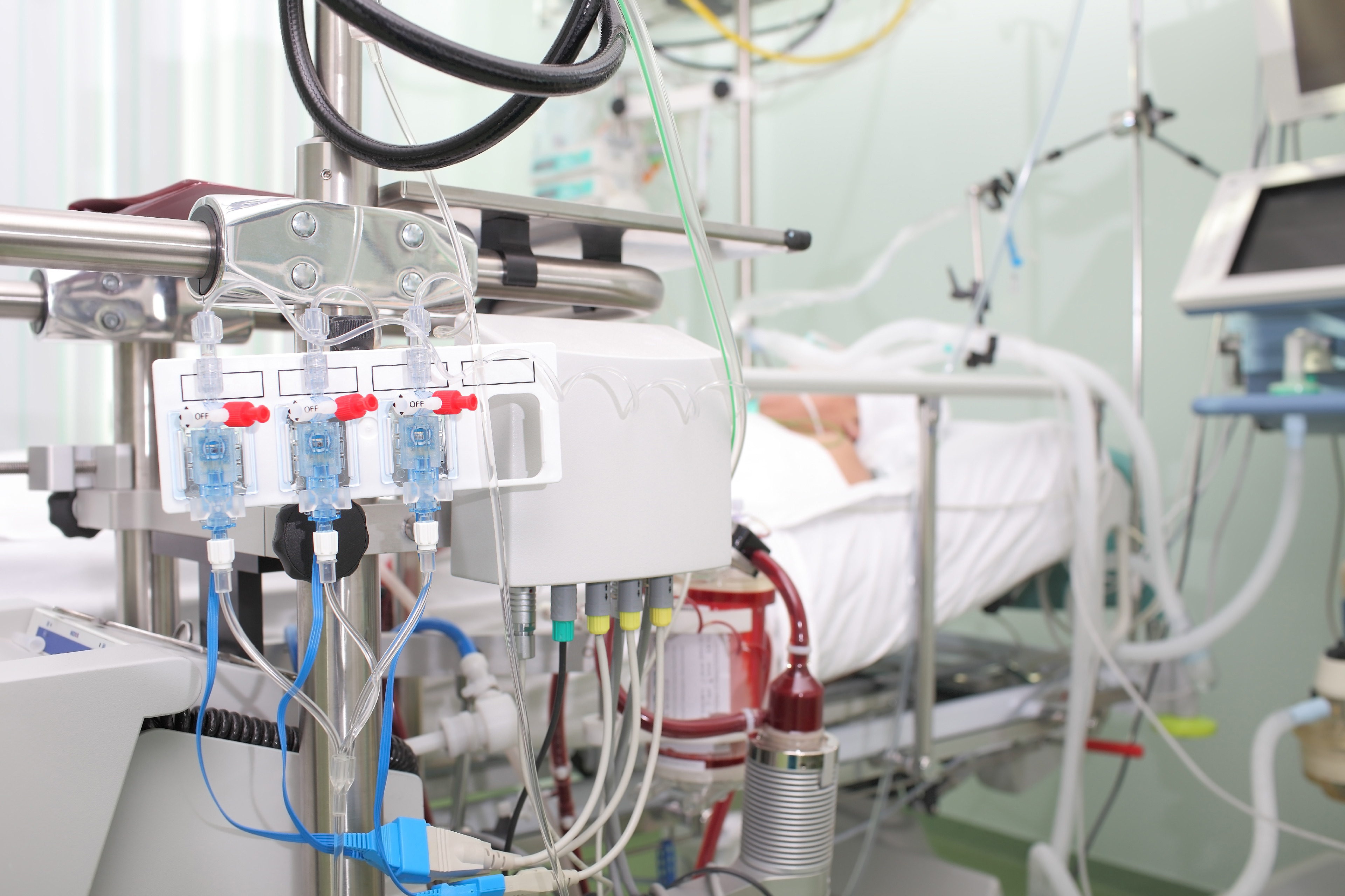 High-acuity ICU equipped with advanced patient monitoring systems, ventilatory support devices, and centralized critical care management